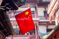 Red national flag of China against old chinese buildings at Yuyuan Garden in Shanghai, China Royalty Free Stock Photo