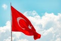 Red national flag of Turkey waving in blue sky. Royalty Free Stock Photo