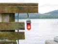 Red navigation light hanging from railing on wharf showing entry direction Royalty Free Stock Photo