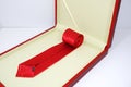 A red necktie rolled on gift box with white background close-up view Royalty Free Stock Photo