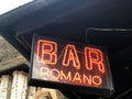 Red neon bar sign close-up. Bar romano. Italian. Gastro tour Royalty Free Stock Photo