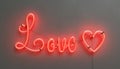 Red neon lamp with the word LOVE and a heart Royalty Free Stock Photo