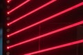 Red neon laser show with horizontal and vertical light bands, abstract pattern, ambient blue light, dynamic composition, music Royalty Free Stock Photo