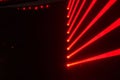 Red neon lights of linear and triangular shapes intersecting and overlapping in various directions against a dark backdrop Royalty Free Stock Photo
