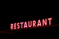 Red neon restaurant sign glowing in the night Royalty Free Stock Photo