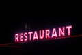 Red neon restaurant sign glowing in the night Royalty Free Stock Photo