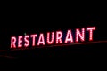 Red neon restaurant sign glowing in the night Royalty Free Stock Photo