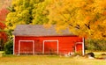 Red New England barn in Autumn with brilliant fall foliage
