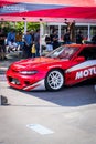 Red Nissan 200SX with Nissan Silvia front end on the paddock of drifting event