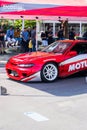 Red Nissan 200SX with Nissan Silvia front end on the paddock of drifting event