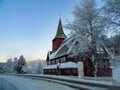 Red Norwegian Stave Church in winter landscape in Norway Royalty Free Stock Photo