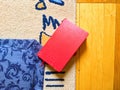red notebook lies on the carpet