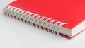 Red notebook on white background.