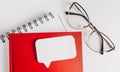 Red notepad, white sticker and glasses on the desk. Mock up in copy space office background. It is important not to forget the Royalty Free Stock Photo