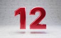 Red number 12. Metallic red color digit isolated on concrete background Royalty Free Stock Photo