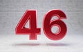 Red number 46. Metallic red color digit isolated on concrete background