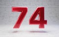 Red number 74. Metallic red color digit isolated on concrete background