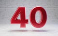 Red number 40. Metallic red color digit isolated on concrete background Royalty Free Stock Photo