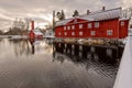 Red ochre old wooden houses over pond