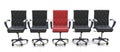 Red office chair among black chairs isolated on white background Royalty Free Stock Photo