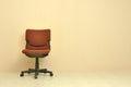 Red office chair over light beige wall background. Royalty Free Stock Photo