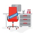 Red office chair with sign vacant on the background with computer table. Hiring job, recruiting or vacancy concept Royalty Free Stock Photo