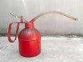 The red oil can is a tool used to apply oil liquid