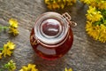 Red oil made from St. John`s wort flowers. Alternative homemade remedy