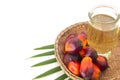 Red Oil Palm seed in a basket and leaf with cooking palm oil in glass on white background