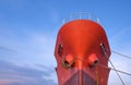 Red Oil Tanker moored at port with mooring rope against blue sky background Royalty Free Stock Photo