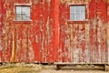Red old barn windows and lonely bench Royalty Free Stock Photo