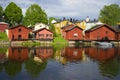 Red old barns on the river bank on a sunny summer day. Old Porvoo, Finland Royalty Free Stock Photo