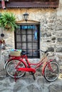 A red old bicycle against a stone wall Royalty Free Stock Photo