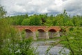 Red old bridge over the river Royalty Free Stock Photo