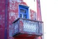 Red old building corner with balcony with blue frame door Royalty Free Stock Photo