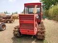 A red old crawler tractor parked on the grass Royalty Free Stock Photo