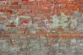 Red old dirty brick wall background. Old damaged brick wall with plaster Royalty Free Stock Photo