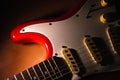 Red Old electric guitar against wood background. Royalty Free Stock Photo