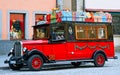 Red old-fashioned car with christmas presents