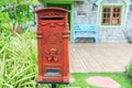 Red old-fashioned mailbox or vintage post box in front of House. Royalty Free Stock Photo