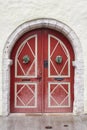 Red old fashioned wooden door on white facade. Tallinn Royalty Free Stock Photo