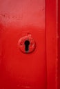 Red old lock key hole in wooden door painted bright Royalty Free Stock Photo