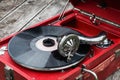 Red old retro gramophone with a vinyl record Royalty Free Stock Photo