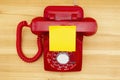 Red old retro rotary landline phone with sticky note Royalty Free Stock Photo