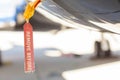 Red old seedy Remove Before Flight Tag on an airplane fuselage Royalty Free Stock Photo