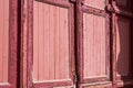 Red old street door with peeled paint in daylight Royalty Free Stock Photo