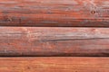 Red old weathered wood surface. wooden background texture wall of log rural house Royalty Free Stock Photo