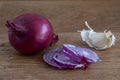 Red onion and garlic clove on wood Royalty Free Stock Photo