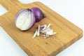 Red onion slices on chopping board isolated on white background Royalty Free Stock Photo