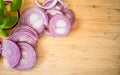 Red onion slices isolated on wooden chopping board Royalty Free Stock Photo